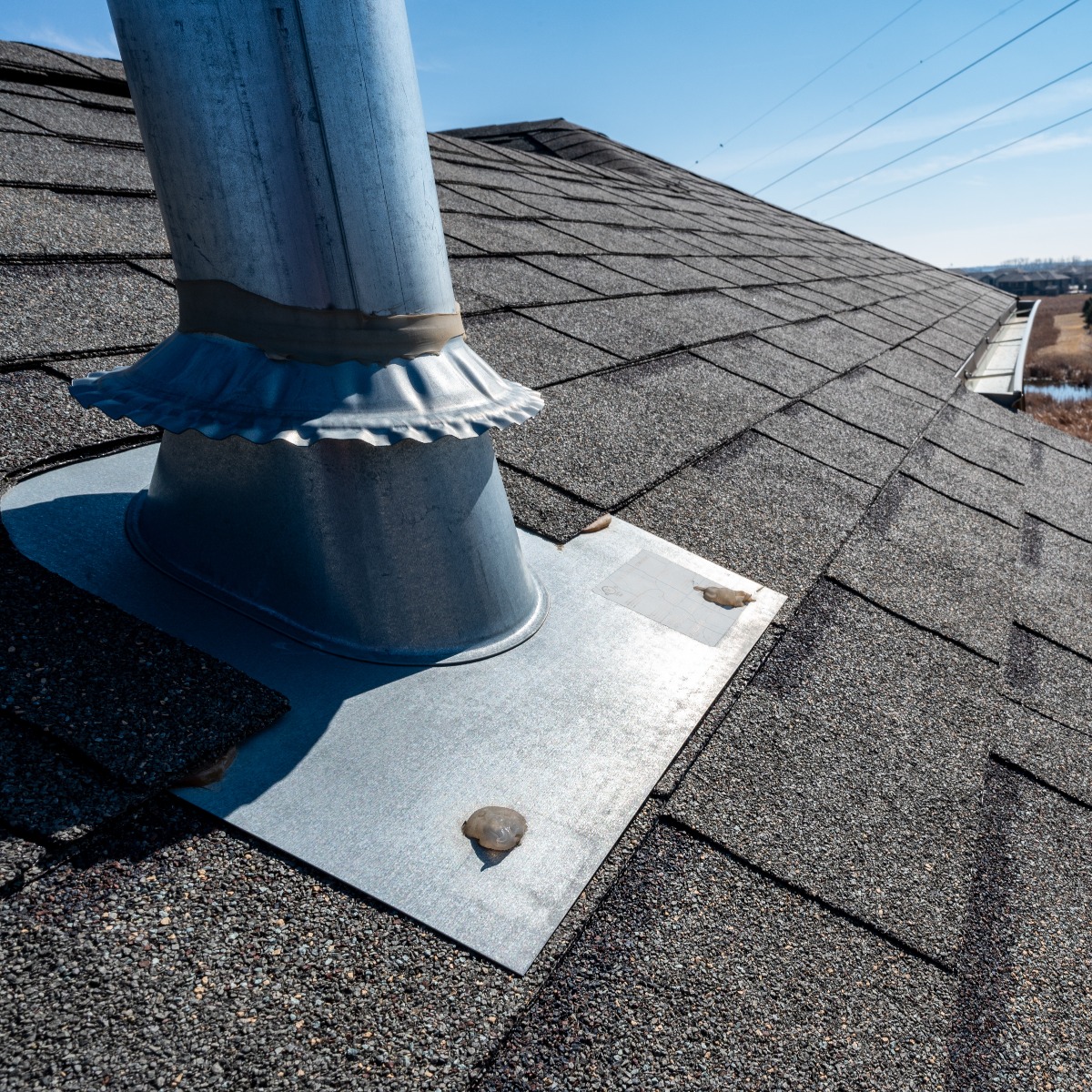 Flashing and weather sealing on vent chimney on a shingle roof
